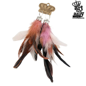 Feather earrings with pink, brown, and white feathers on a white background, branded 'Art by Amy'.